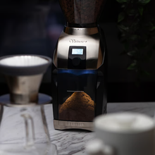 Load image into Gallery viewer, Baratza Virtuoso+ Coffee grinder with coffee beans and a cup on a marble surface